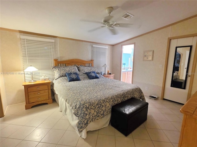 bedroom with crown molding, light tile patterned floors, visible vents, and lofted ceiling