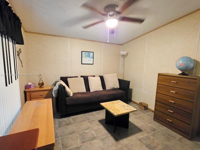 living area featuring crown molding, a ceiling fan, and light tile patterned floors