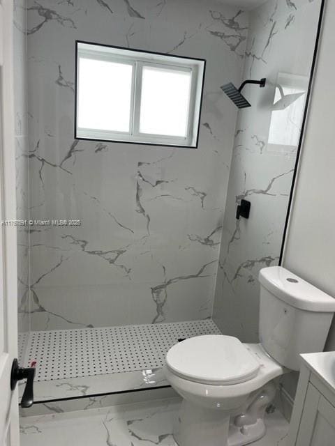 bathroom with a marble finish shower, marble finish floor, toilet, and vanity