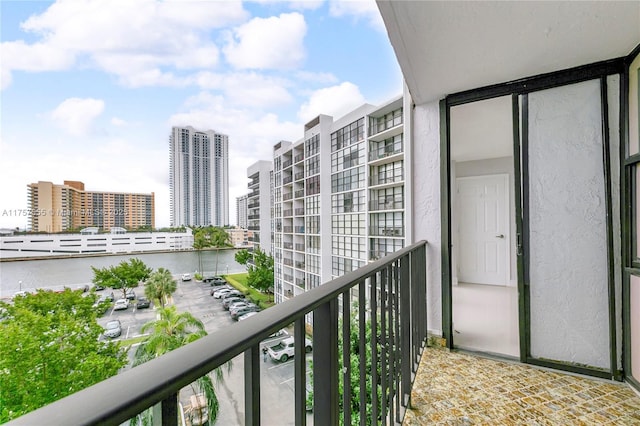 balcony featuring a water view and a view of city