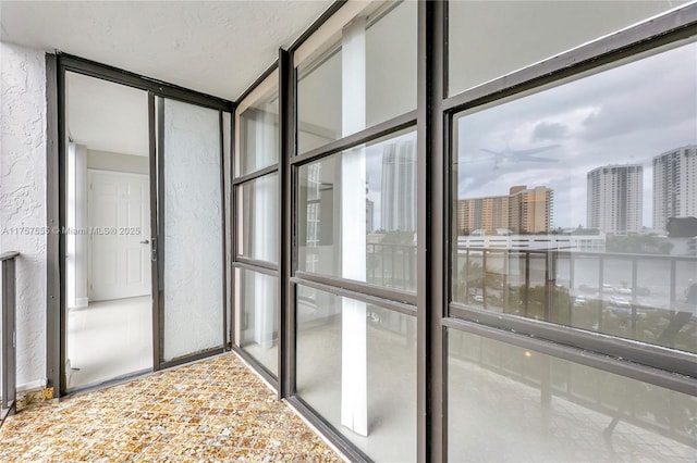 interior space featuring a view of city and a textured wall