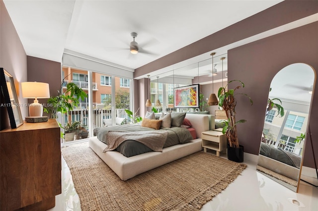 bedroom with access to outside and a ceiling fan