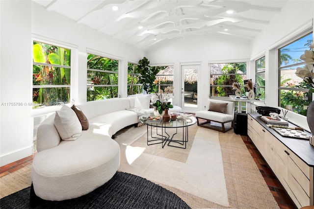 sunroom with lofted ceiling with beams and a healthy amount of sunlight