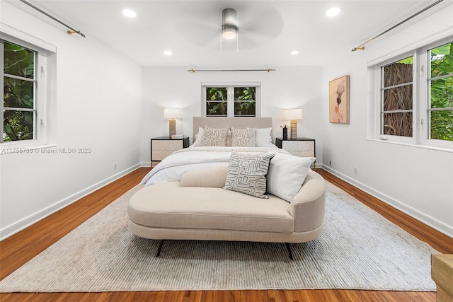 bedroom with a ceiling fan, baseboards, wood finished floors, and recessed lighting