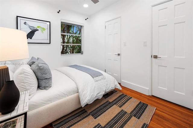 bedroom featuring ceiling fan, baseboards, wood finished floors, and recessed lighting