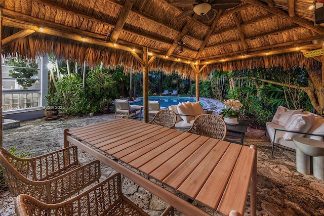 view of patio featuring an outdoor pool, outdoor dining space, outdoor lounge area, and a gazebo