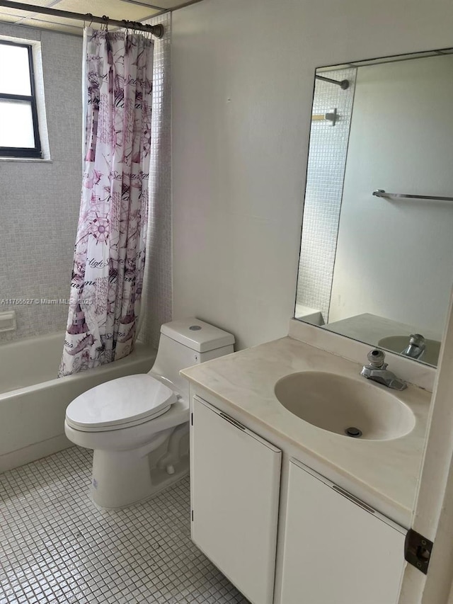 full bath with toilet, shower / tub combo, vanity, and tile patterned floors