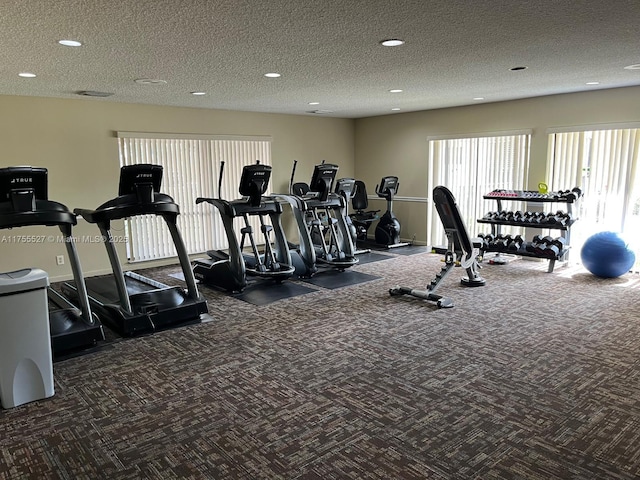 workout area with a textured ceiling, recessed lighting, carpet flooring, and baseboards