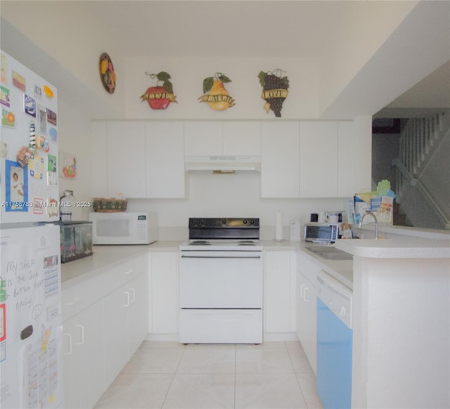 kitchen featuring light tile patterned floors, light countertops, white cabinetry, white appliances, and under cabinet range hood