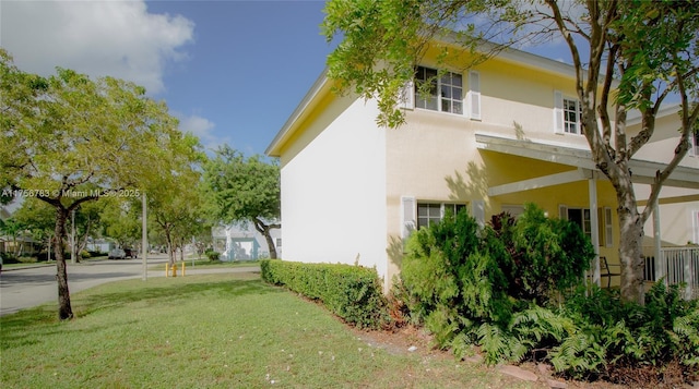 view of home's exterior with a yard and stucco siding