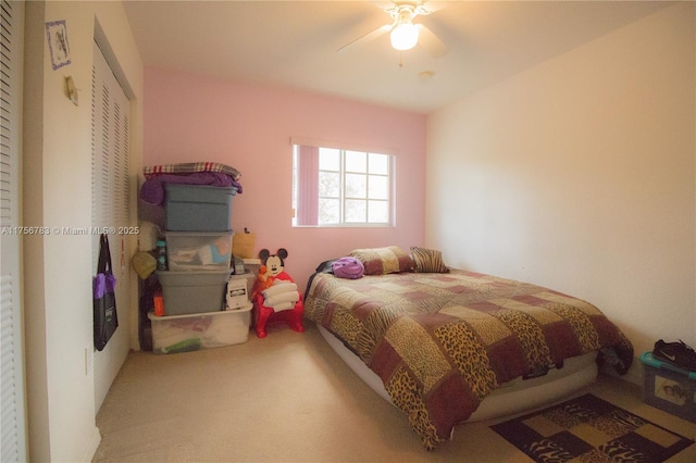 carpeted bedroom with a ceiling fan and a closet