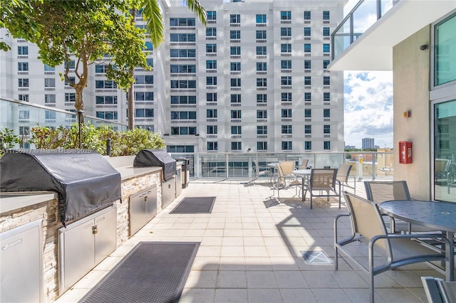 view of patio featuring exterior kitchen, outdoor dining area, and grilling area