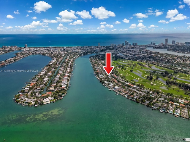 birds eye view of property featuring a water view and a city view