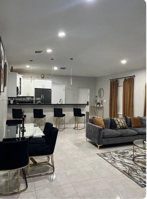 living area featuring recessed lighting and light tile patterned flooring