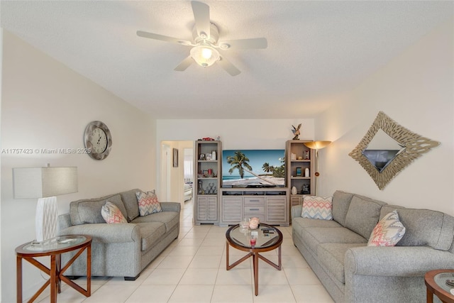 living area featuring light tile patterned floors, ceiling fan, and a textured ceiling