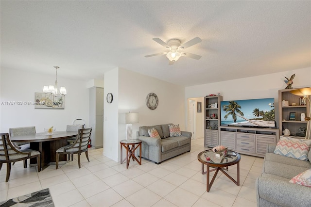 living area with light tile patterned floors, a textured ceiling, and ceiling fan with notable chandelier