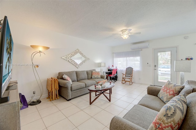 living room with a wall unit AC, ceiling fan, a textured ceiling, and light tile patterned flooring