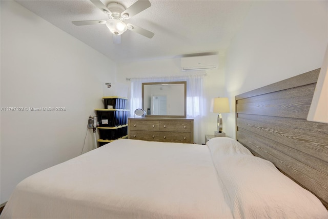 bedroom featuring a wall unit AC and a ceiling fan