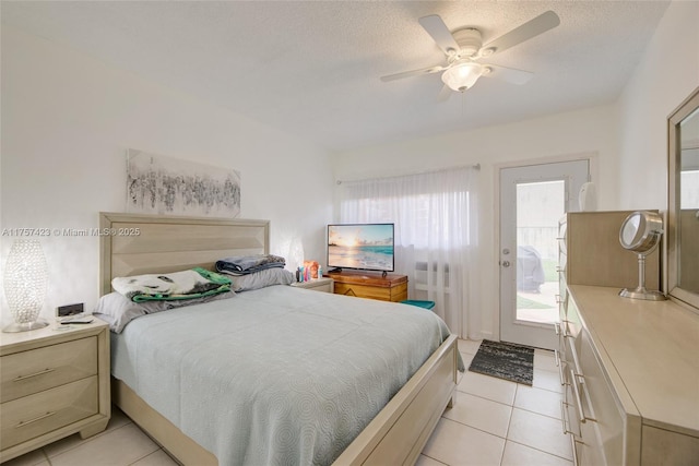 bedroom with a ceiling fan, access to exterior, a textured ceiling, and light tile patterned floors