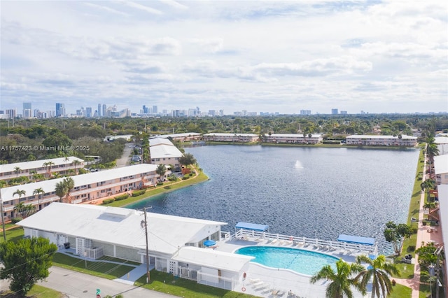 birds eye view of property featuring a water view and a city view