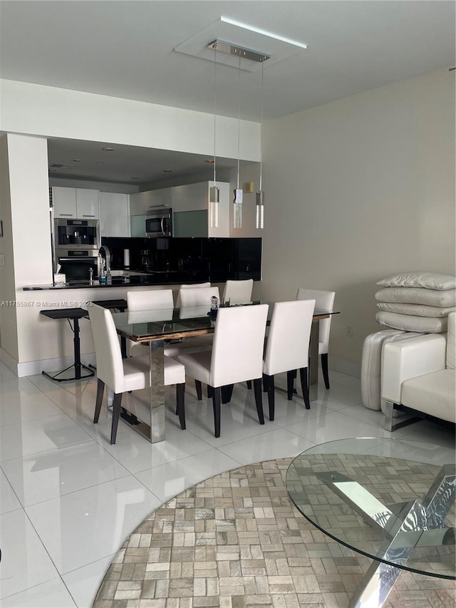 dining space featuring light tile patterned floors