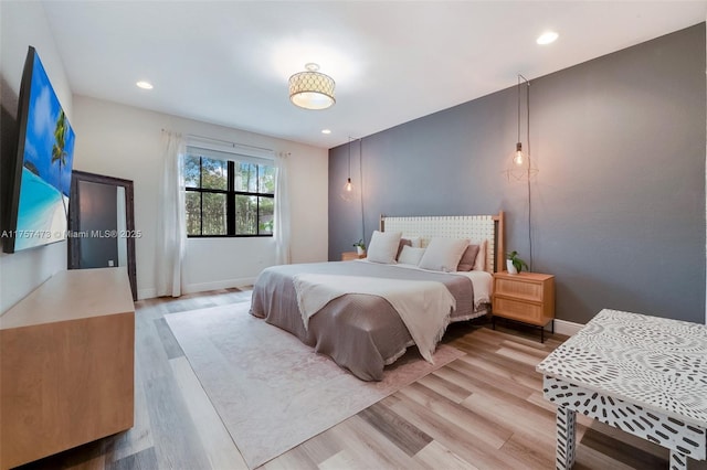 bedroom with recessed lighting, baseboards, and wood finished floors