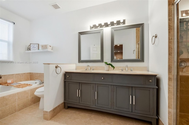 bathroom with tile patterned flooring, a sink, and visible vents