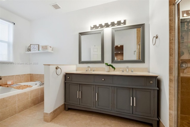 bathroom with tile patterned flooring, visible vents, and a sink