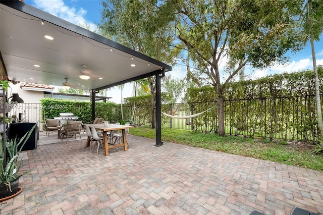 view of patio / terrace with a fenced backyard, outdoor dining area, and a ceiling fan