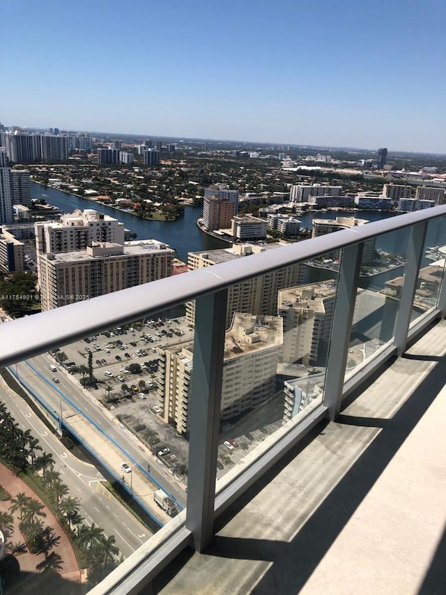 balcony featuring a city view and a water view