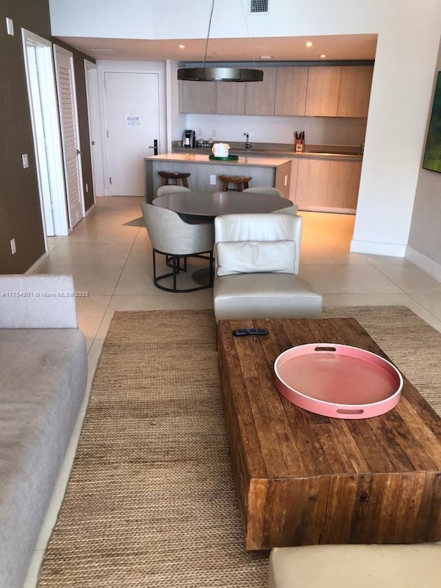 interior space with light tile patterned floors, baseboards, and visible vents