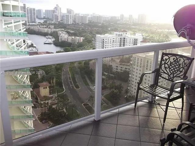 balcony featuring a view of city and a water view