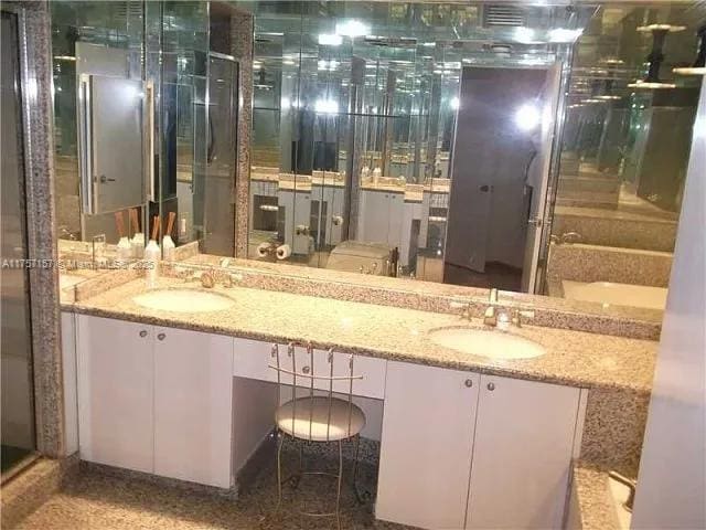 bathroom featuring double vanity and a sink