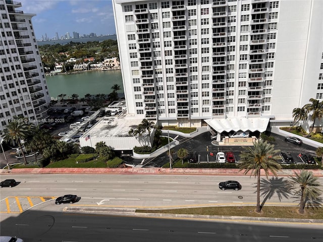 view of building exterior with a water view and a view of city