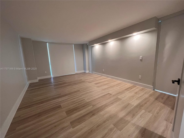 empty room with wood finished floors and baseboards