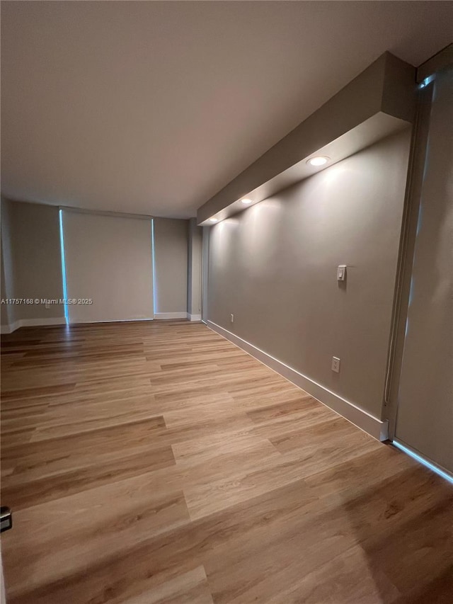 interior space featuring light wood-style floors and baseboards