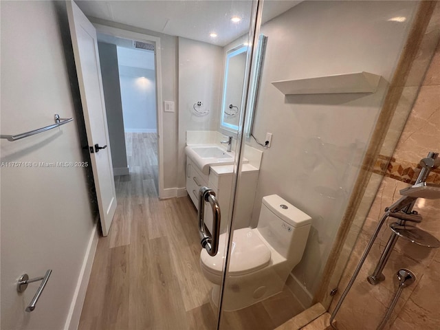 full bath with toilet, wood finished floors, visible vents, vanity, and baseboards