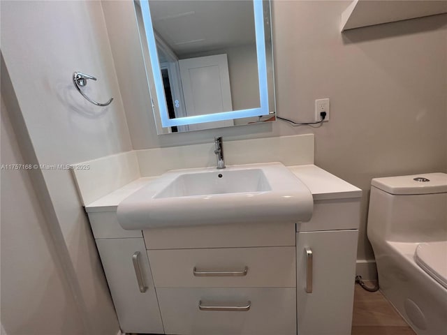 bathroom featuring toilet and vanity