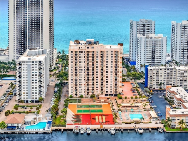 birds eye view of property with a water view and a city view