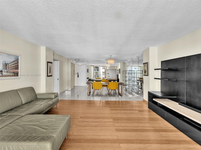 living area with a textured ceiling and wood finished floors