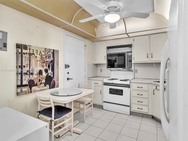 kitchen featuring light tile patterned floors, white appliances, a ceiling fan, white cabinetry, and light countertops