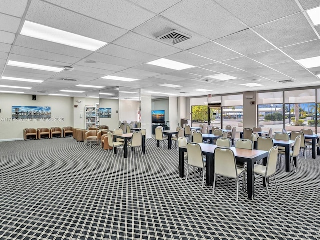 carpeted dining room featuring visible vents and a drop ceiling