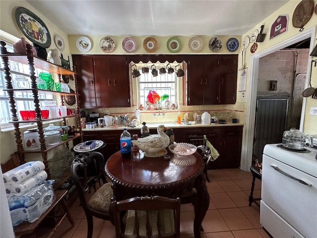 kitchen with light tile patterned floors, decorative backsplash, and light countertops