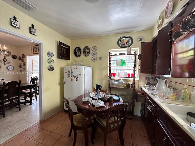 dining space featuring visible vents, plenty of natural light, and tile patterned floors