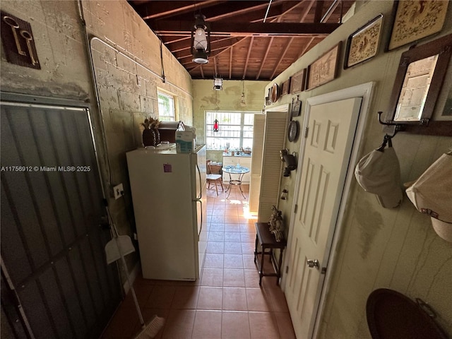 corridor with tile patterned flooring, wood ceiling, and lofted ceiling