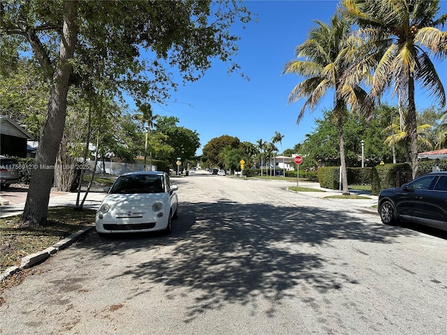 view of road with traffic signs, curbs, and sidewalks