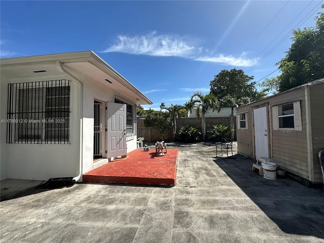 view of patio with an outbuilding and a fenced backyard