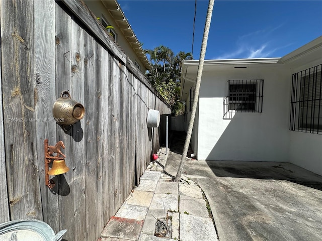 view of side of home featuring a patio area and stucco siding