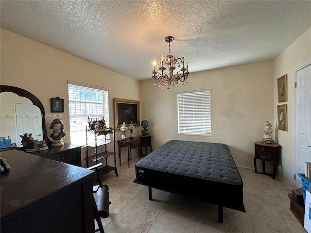 bedroom featuring a textured ceiling, light tile patterned floors, and a notable chandelier