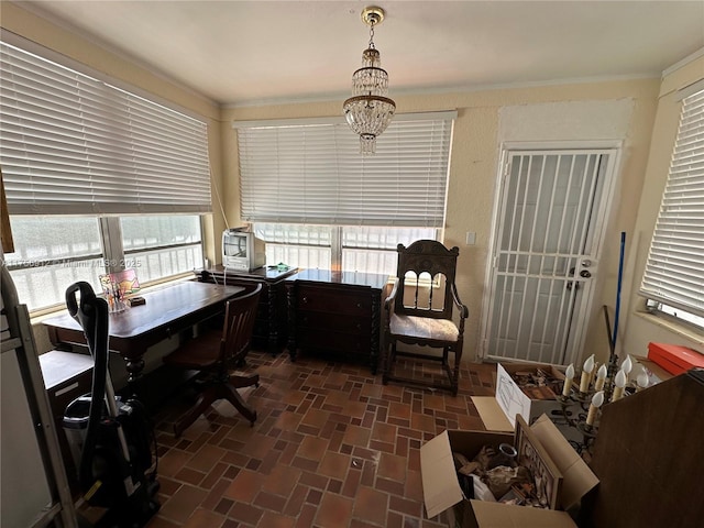 office area featuring brick floor and crown molding